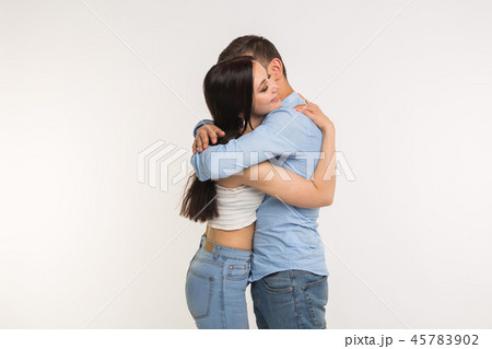 Handsome man hugging his girlfriend on white background 45783902