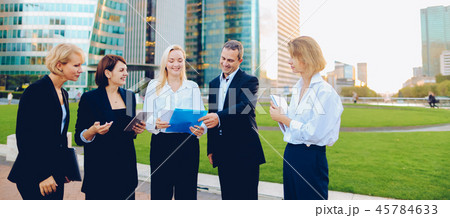 Management team changing ideas about new project with tablet and Management team changing ideas about new project with tablet and 45784633