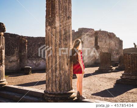 Stylish woman in a red dress looking into the distance 45785434
