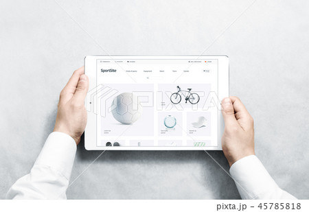 Hands holding tablet with sport webstore mock up on screen Hands holding tablet with sport webstore mock up on screen 45785818