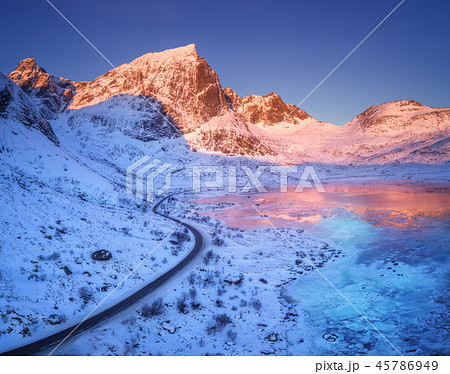 Aerial view of winding road, mountains and sky Aerial view of winding road, mountains and sky 45786949