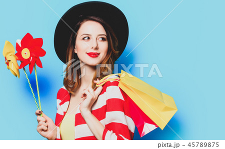Woman with pinwheels and shopping bags Woman with pinwheels and shopping bags 45789875