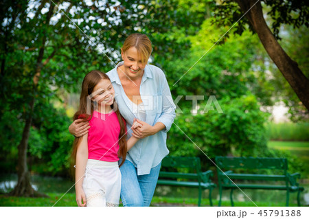Happy mother and little kid daughter in park. 45791388