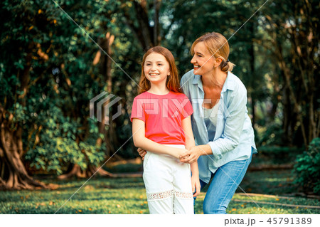 Happy mother and little kid daughter in park. Happy mother and little kid daughter in park. 45791389