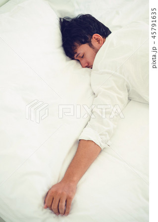 Young man sleep in bed in the bedroom. 45791635
