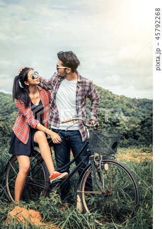 Happy young couple ride bicycle on the hills. Happy young couple ride bicycle on the hills. 45792268