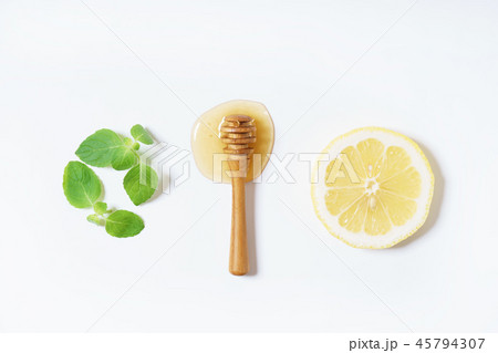 lemon, honey and mint leaves on white background 45794307