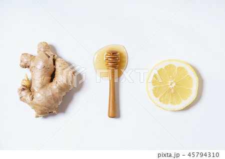 ginger, honey and lemon on white background ginger, honey and lemon on white background 45794310