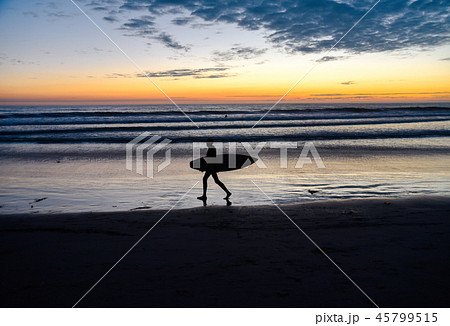 Silhouette of a surfer at sunset 45799515