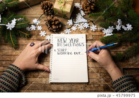 Woman writing new year resolution list 45799975