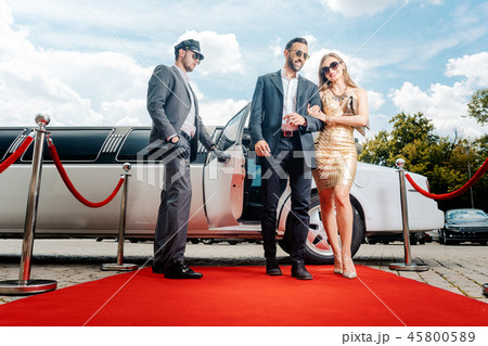 Couple arriving with limousine walking red carpet Couple arriving with limousine walking red carpet 45800589