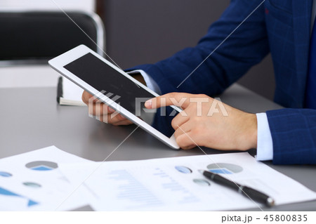 Businessman using touchpad at meeting, closeup of hands 45800835