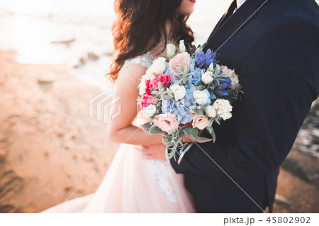 Bride holding big and beautiful wedding bouquet with flowers 45802902
