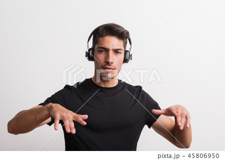 Portrait of a joyful young hispanic man with headphones in a studio. Copy space. Portrait of a joyful young hispanic man with headphones in a studio. Copy space. 45806950