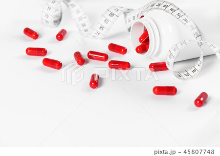 Red pills measuring tape Diet health detox concept Red pills measuring tape Diet health detox concept 45807748