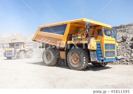 Dump trucks moving in a mine 45811395