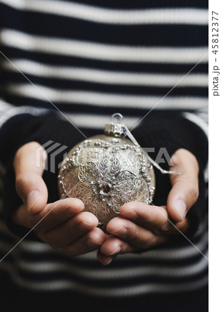 man with an ornamented christmas ball 45812377
