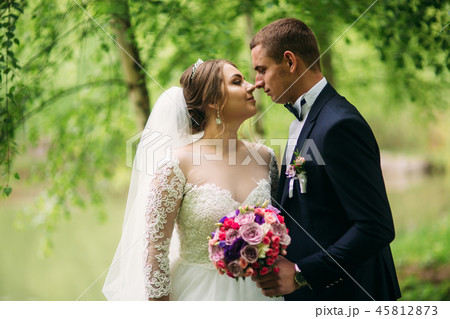Groom and bride kiss each other in their wedding day Groom and bride kiss each other in their wedding day 45812873