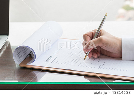 Applicant filling in company application form  45814558