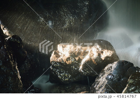 waterfall in cave behind rock in forest waterfall in cave behind rock in forest 45814767