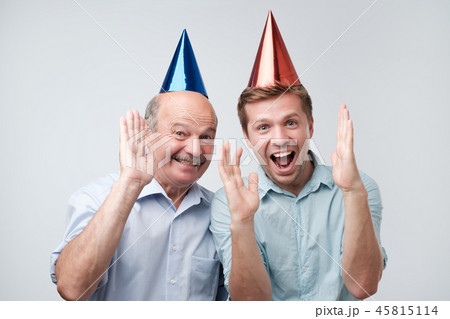 Mature father and son celebrating birthday or other family holiday. 45815114