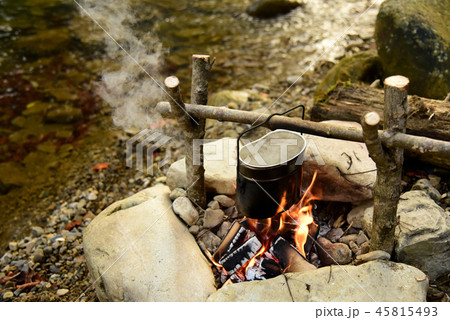 Cooking food in pot over campfire outdoor 45815493