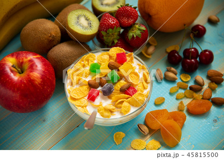 Tasty cornflakes with milk and fruits in glass bowl Tasty cornflakes with milk and fruits in glass bowl 45815500