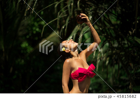 Sexy slim brunette young female watering herself  45815682