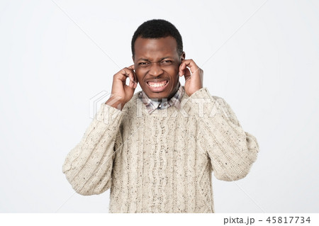Portrait of furious afroamerican man covering his ears Portrait of furious afroamerican man covering his ears 45817734