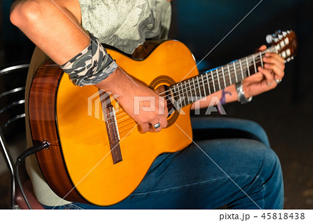 Man playing yellowe an acoustic guitar closeup Man playing yellowe an acoustic guitar closeup 45818438