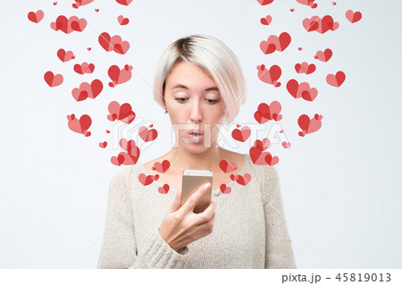 girl looking at mobile phone screen in surprise reading sms. Declaration of love concept 45819013