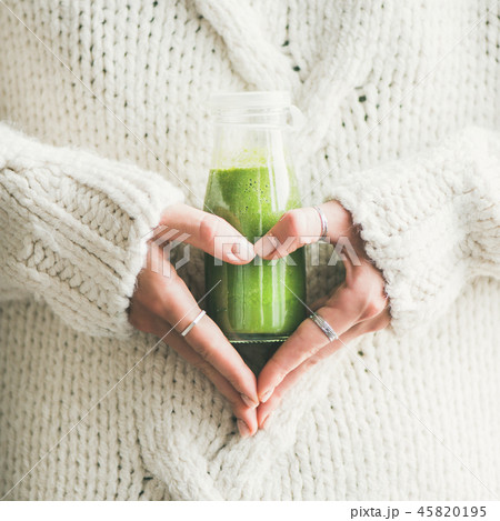 Winter seasonal smoothie drink detox in woman's hands, square crop Winter seasonal smoothie drink detox in woman's hands, square crop 45820195