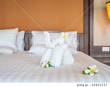 White elephant towel and comfortable pillow on bed White elephant towel and comfortable pillow on bed 45825537