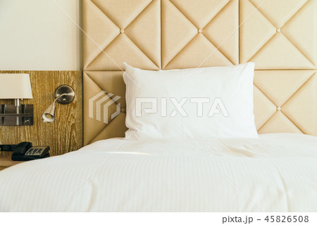 White comfortable pillow on bed decoration in hotel bedroom White comfortable pillow on bed decoration in hotel bedroom 45826508