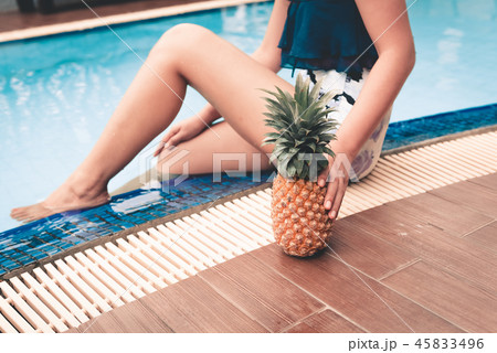 Close-up portrait of woman holding pineapple Close-up portrait of woman holding pineapple 45833496