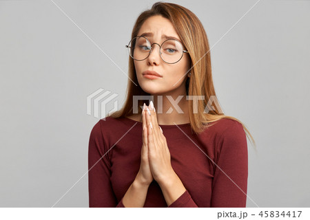 woman holds her hands in a prayer gesture woman holds her hands in a prayer gesture 45834417