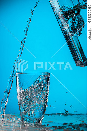 Man pours water from glass 45839299