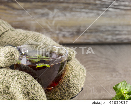 Glass Cup with tea and mint on wooden background 45839357