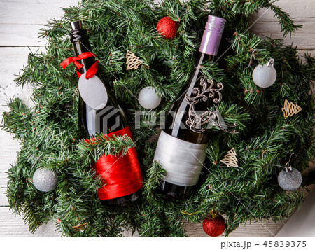 Photo of spruce branches with two bottles of wine, blank greeting card 45839375