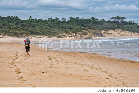 Pilgrim with backpack going on beach 45843394