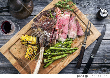 Barbecue Wagyu Tomahawk Steak as top view on burnt 45844067