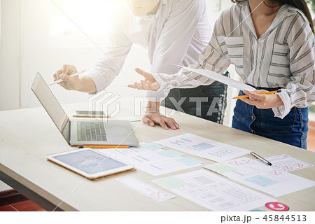 Crop coworkers with papers and laptop in sunlight 45844513