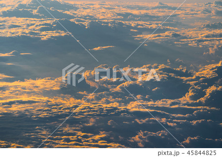 Sunrise above fluffy clouds from an airplane window with sunligh 45844825