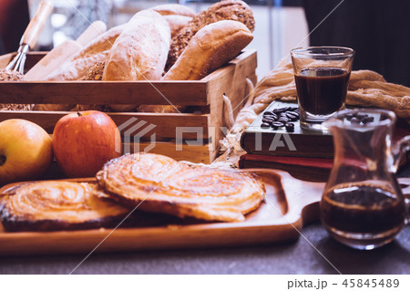 Baked breads, apples and coffee on a table. Baked breads, apples and coffee on a table. 45845489
