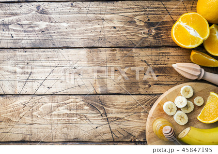 Pieces of fresh orange juice on wooden background. 45847195