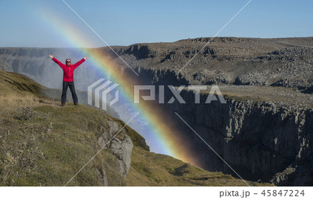 Happy tourist on canyon edge and rainbow near Happy tourist on canyon edge and rainbow near 45847224