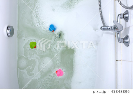 Pink, green and blue duck in a bathtub 45848896