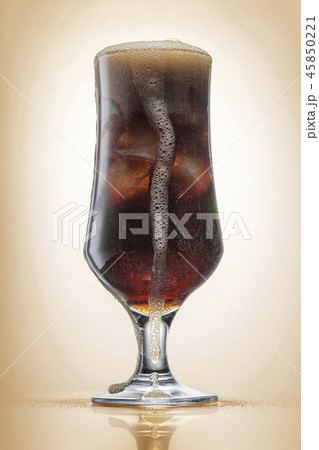 Crowded glass with cola and ice, light toning Crowded glass with cola and ice, light toning 45850221