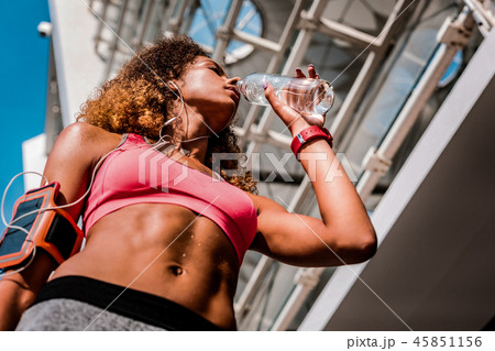 Low angle of a young woman drinking water 45851156