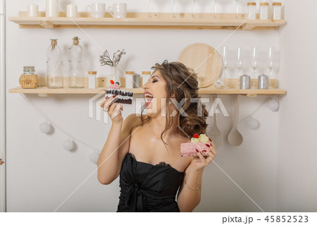 Very beautiful and cheerful woman holding cakes in 45852523